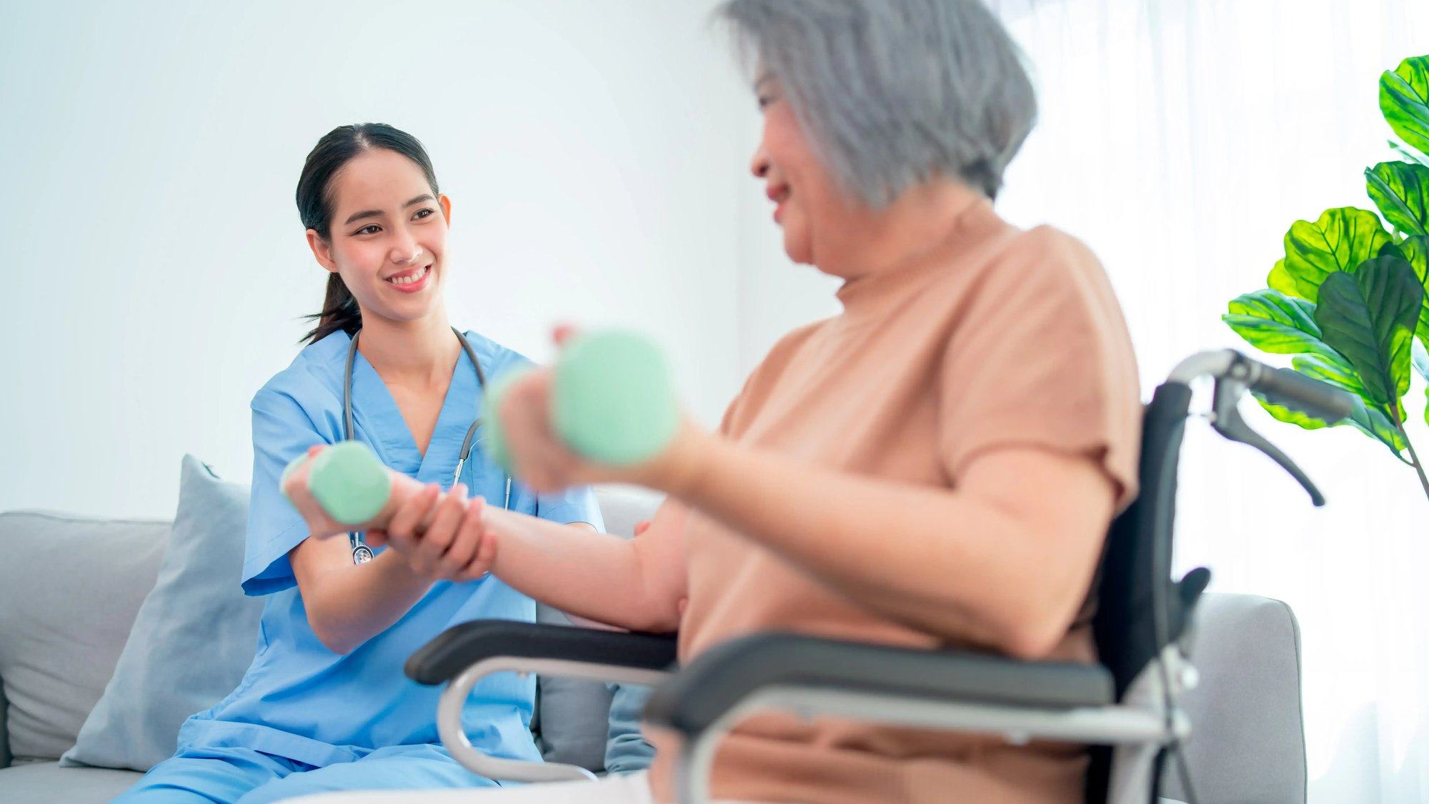 asian-young-nurse-help-and-support-elderly-or-seni-2023-11-27-05-04-47-utc-1