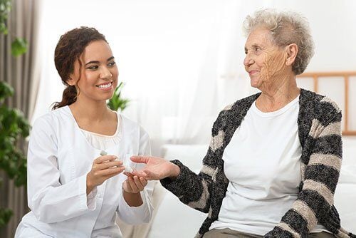 Nurse And Elderly Woman